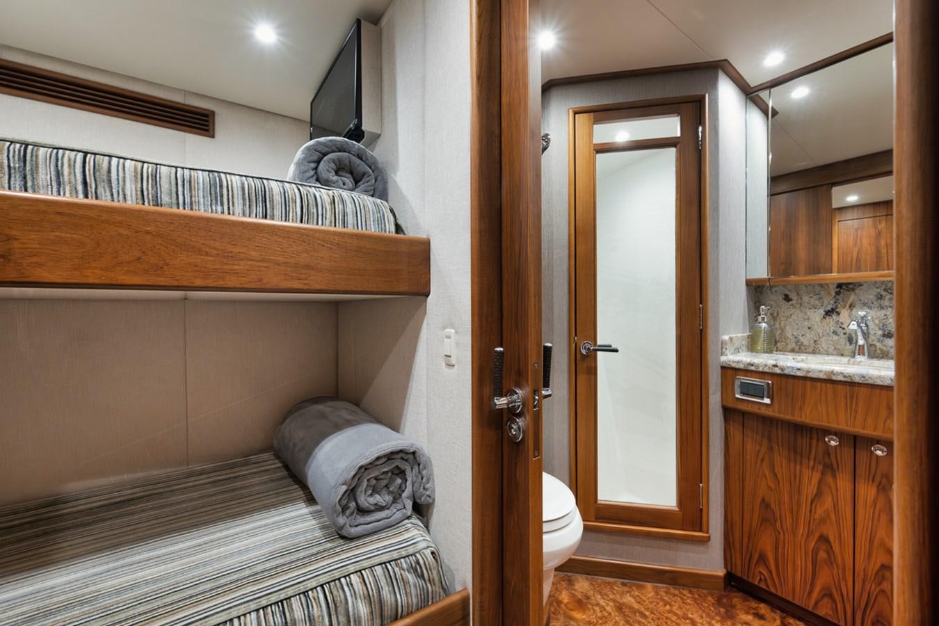 a bathroom with a bed and a sink aboard ARTEMIS Yacht for Sale