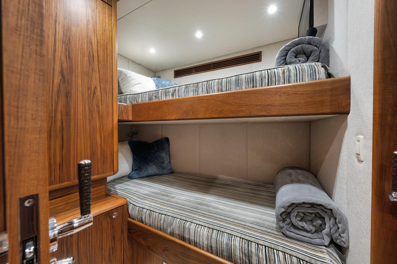 a bed with a wood headboard aboard ARTEMIS Yacht for Sale
