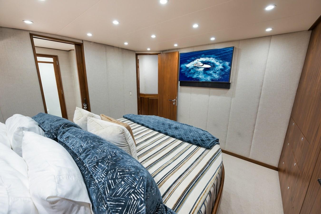 a bed with a blue blanket aboard ARTEMIS Yacht for Sale