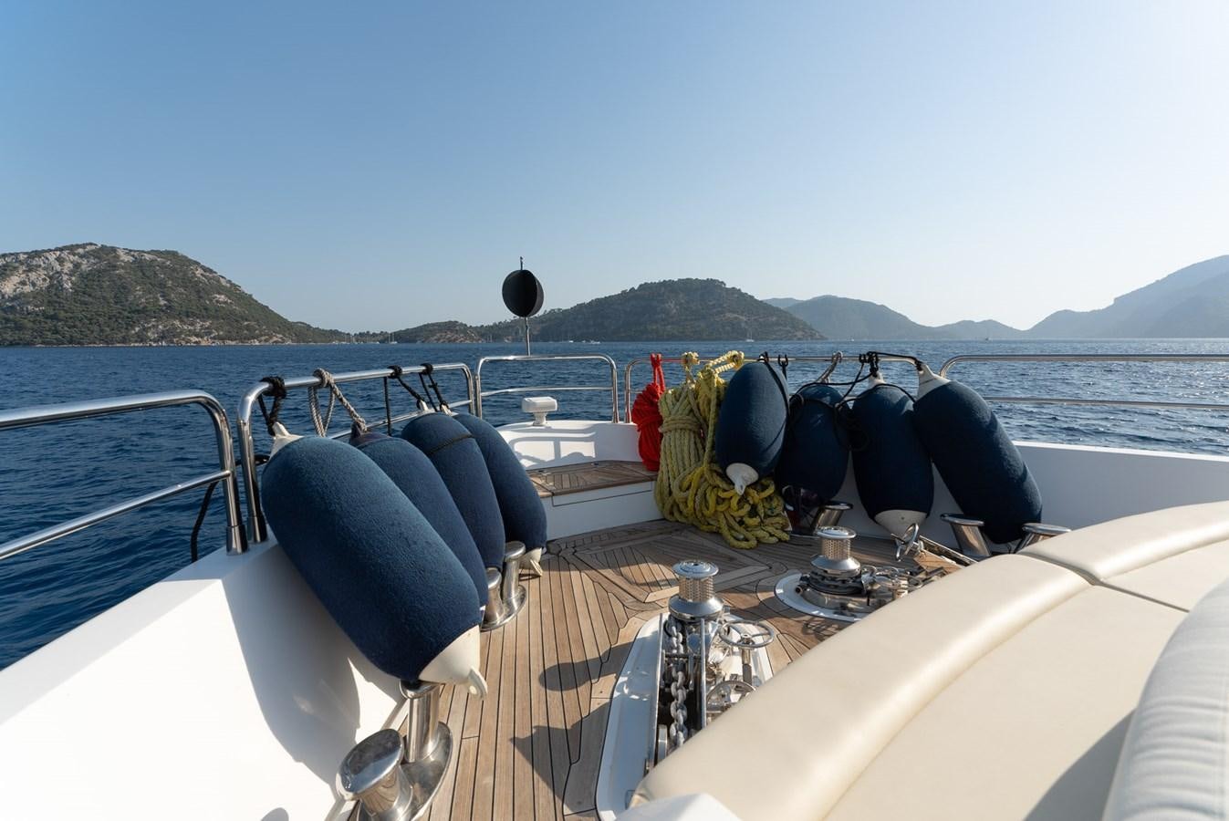a boat with a person's legs on the deck aboard ROUND MIDNIGHT Yacht for Sale