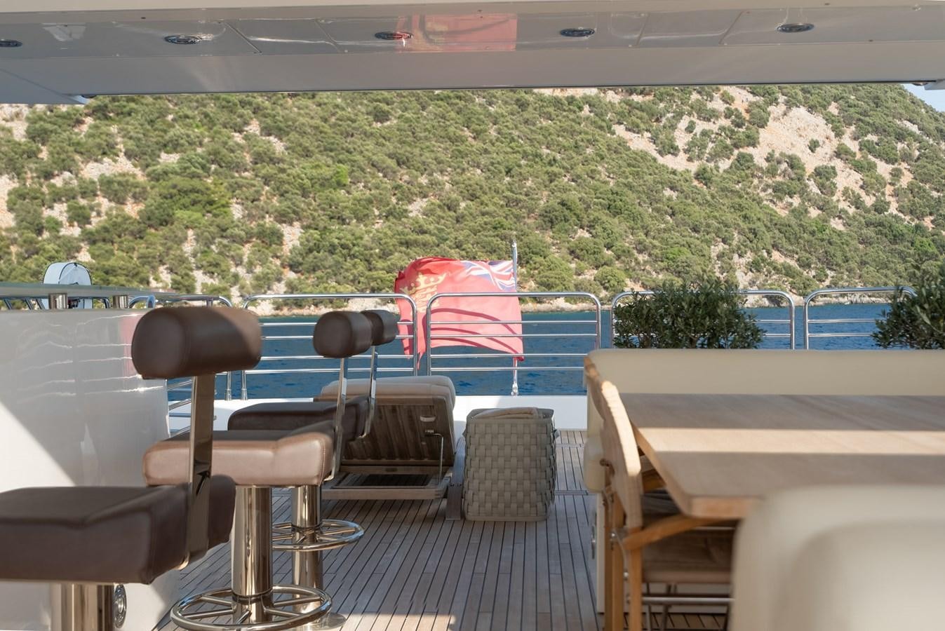 a deck with chairs and a table aboard ROUND MIDNIGHT Yacht for Sale