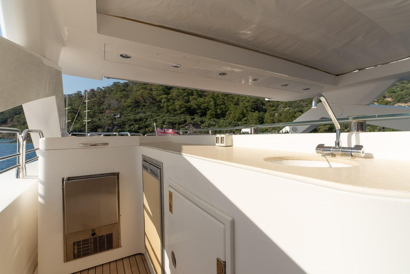 a large white kitchen with a large window and a view of the trees aboard ROUND MIDNIGHT Yacht for Sale