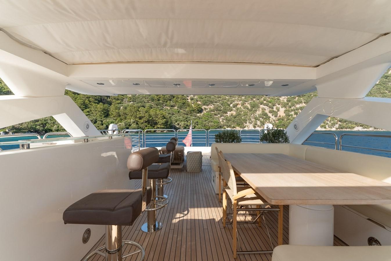 a room with a table and chairs aboard ROUND MIDNIGHT Yacht for Sale