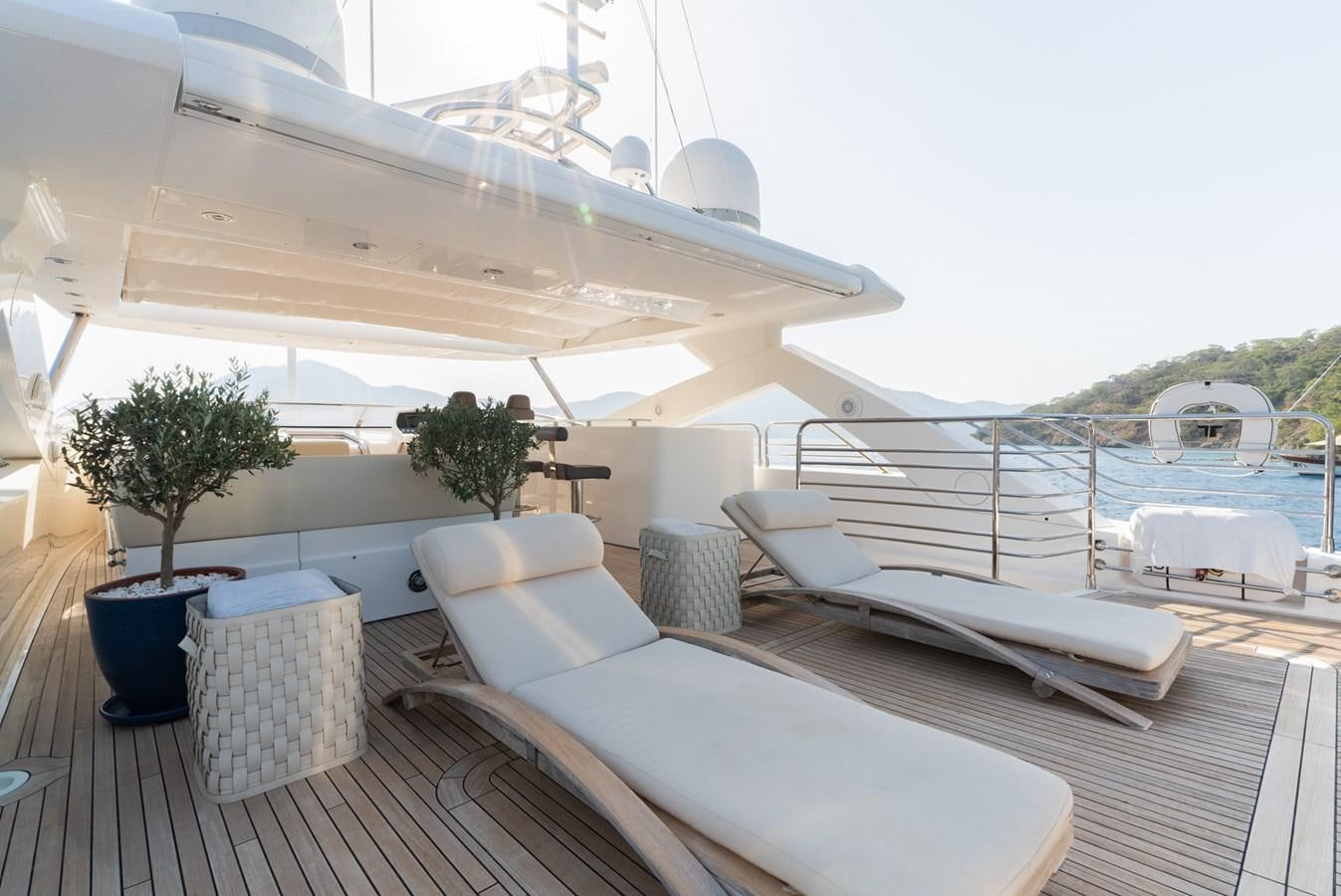 a deck with a large boat and a table on it aboard ROUND MIDNIGHT Yacht for Sale