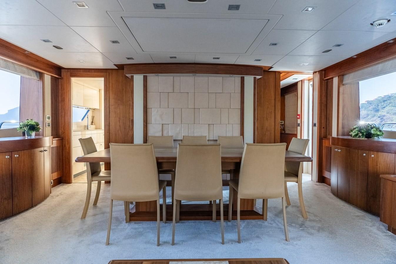 a room with a table and chairs aboard ROUND MIDNIGHT Yacht for Sale
