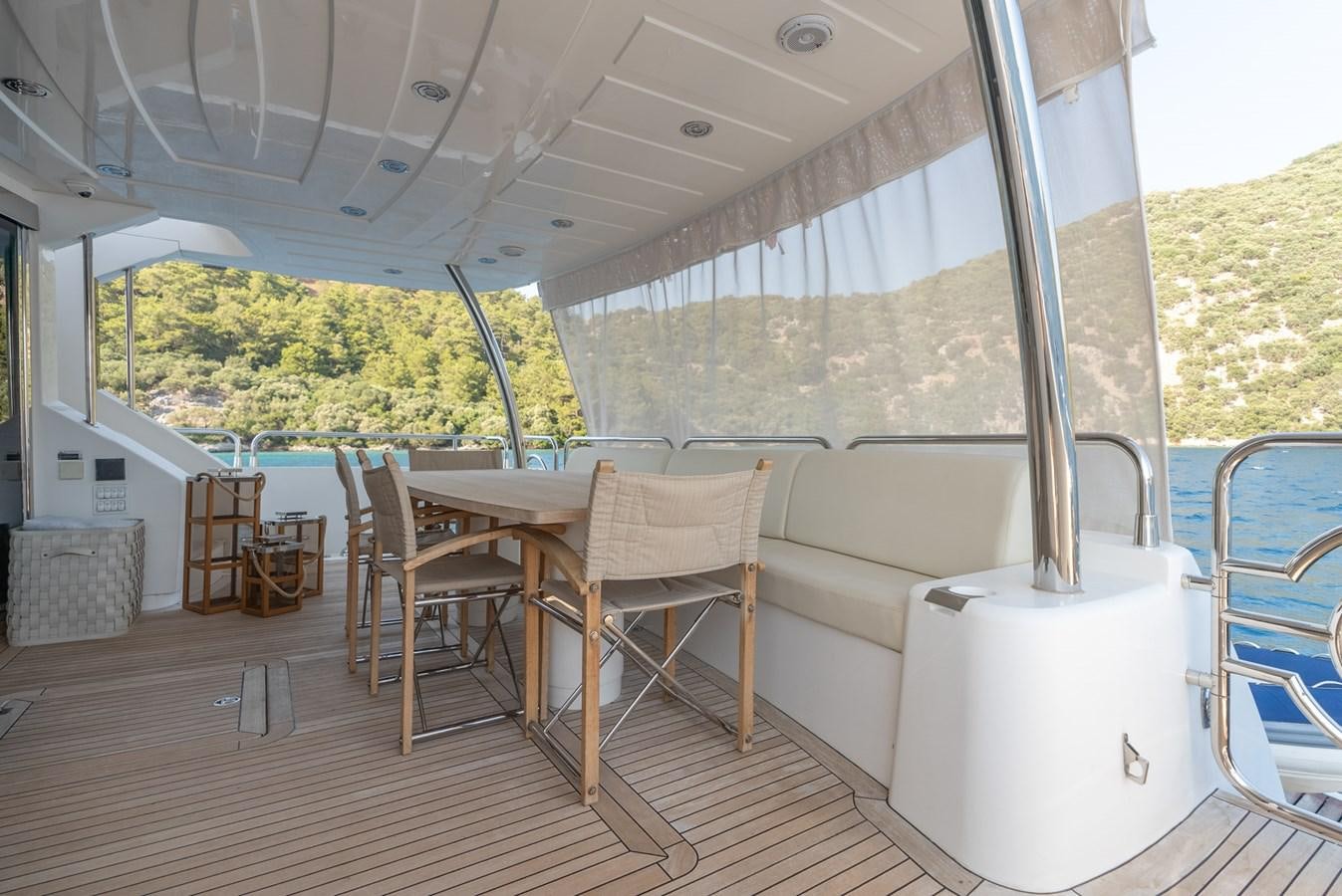 a room with a table and chairs aboard ROUND MIDNIGHT Yacht for Sale