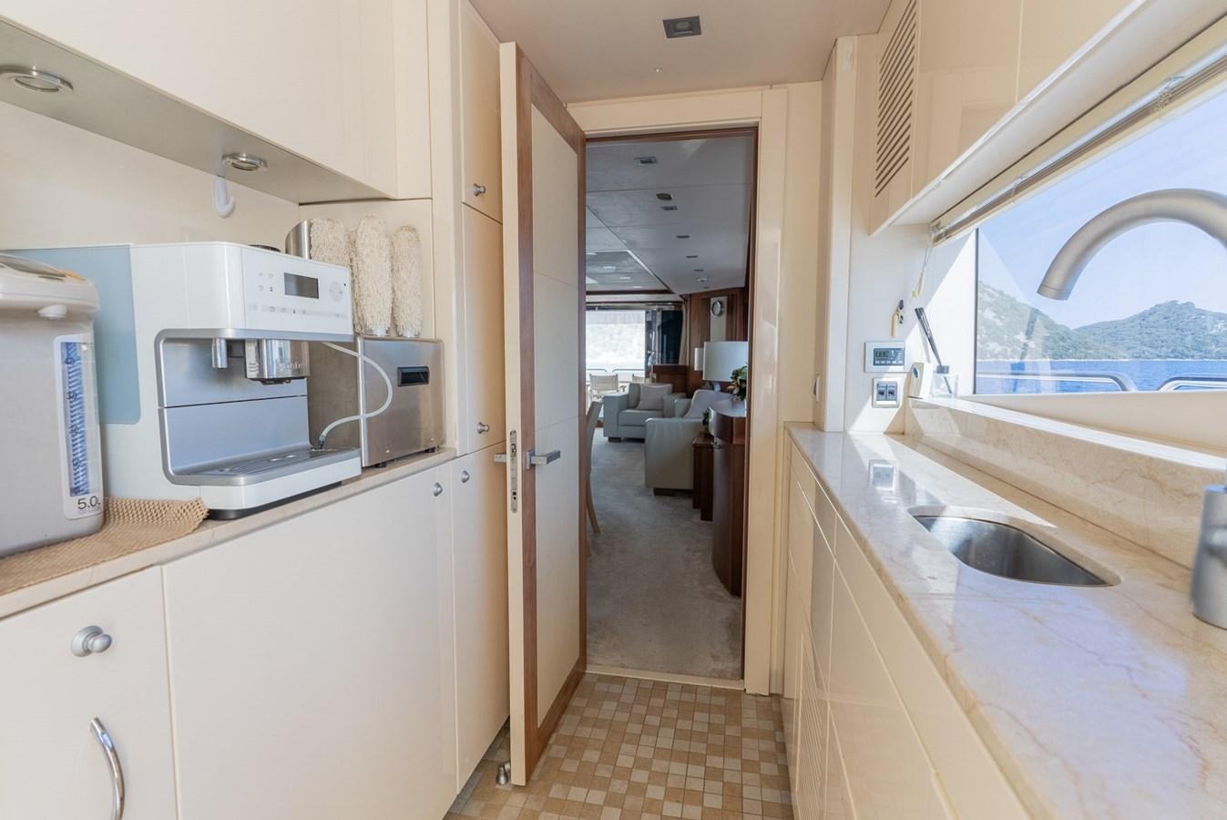 a kitchen with a sink and microwave aboard ROUND MIDNIGHT Yacht for Sale