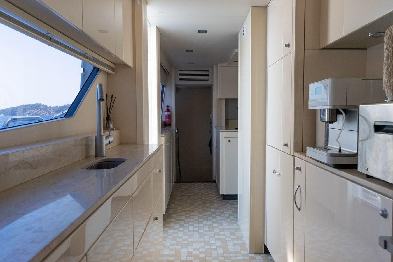 a kitchen with a sink and a window aboard ROUND MIDNIGHT Yacht for Sale