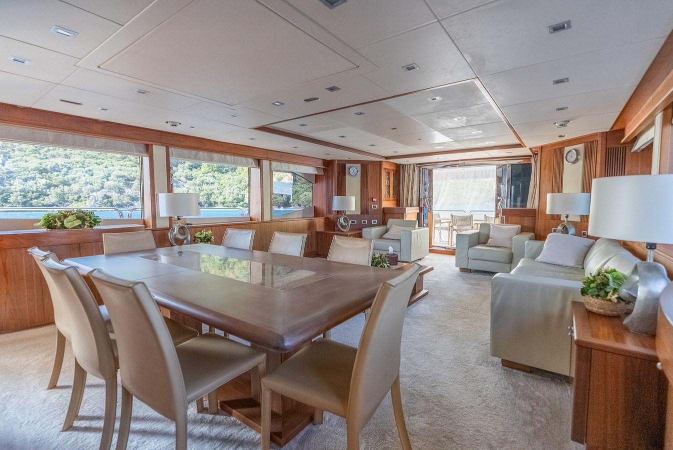 a large living room with a large table and chairs aboard ROUND MIDNIGHT Yacht for Sale