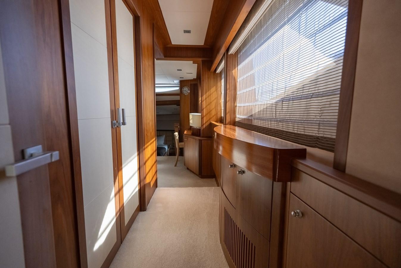a hallway with wooden cabinets aboard ROUND MIDNIGHT Yacht for Sale