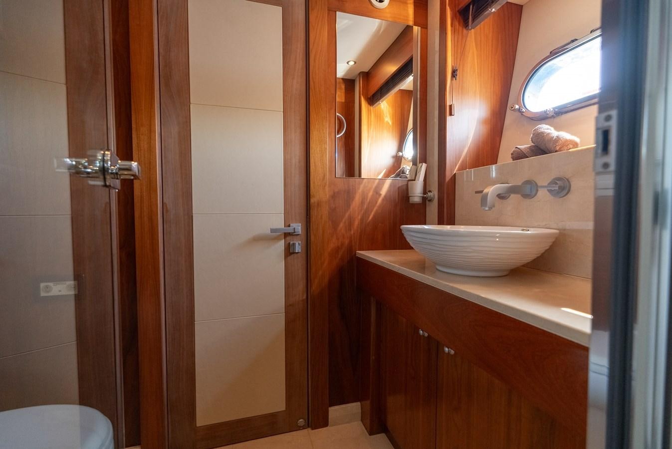 a bathroom with a sink and a mirror aboard ROUND MIDNIGHT Yacht for Sale