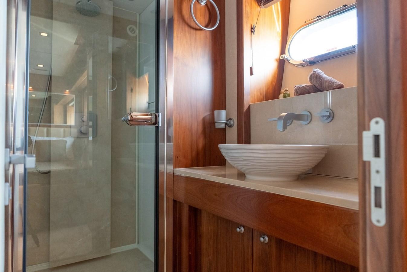 a bathroom with a sink and a mirror aboard ROUND MIDNIGHT Yacht for Sale