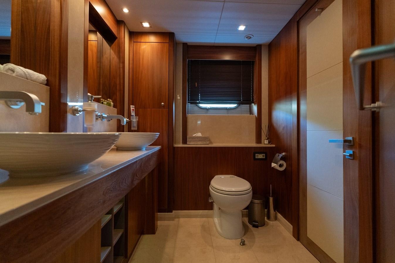 a bathroom with a sink and a toilet aboard ROUND MIDNIGHT Yacht for Sale