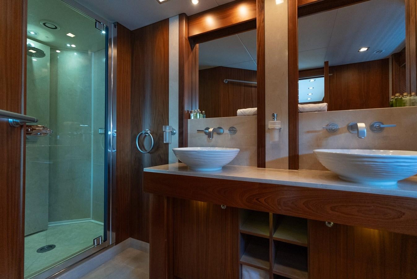 a bathroom with sinks and mirrors aboard ROUND MIDNIGHT Yacht for Sale