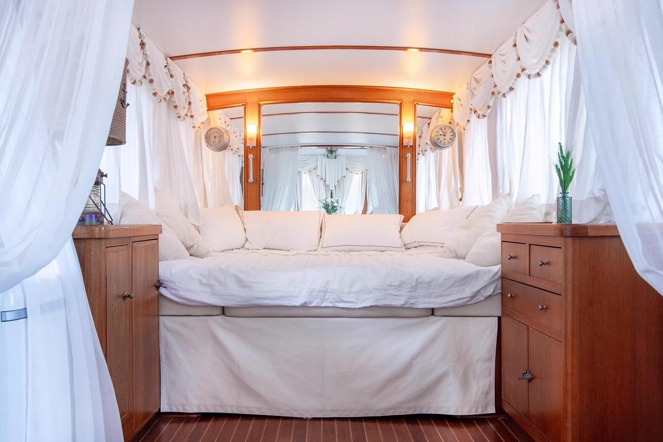 a room with a bed and a mirror aboard FOREVER Yacht for Sale