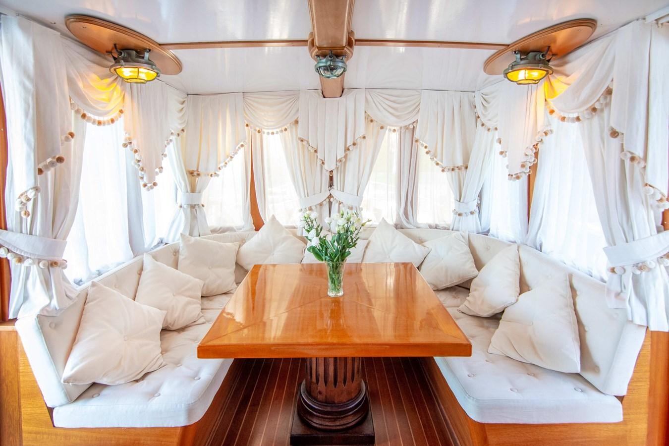 a room with a table and chairs aboard FOREVER Yacht for Sale