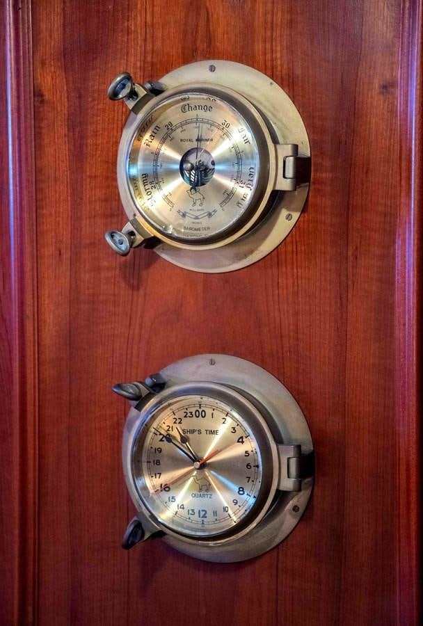 a couple of watches on a wood surface aboard FOREVER Yacht for Sale