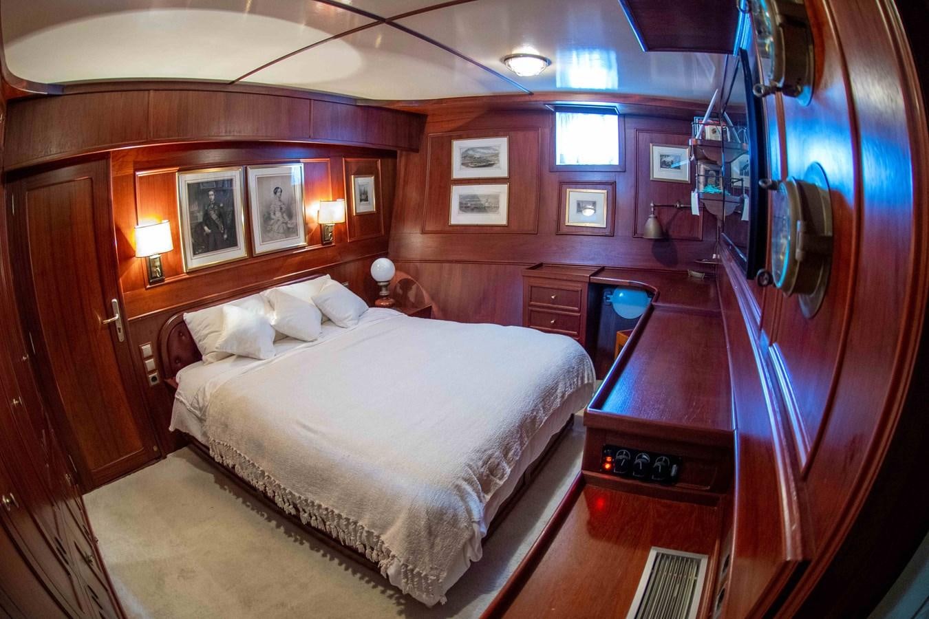 a bedroom with a bed and a telephone aboard FOREVER Yacht for Sale
