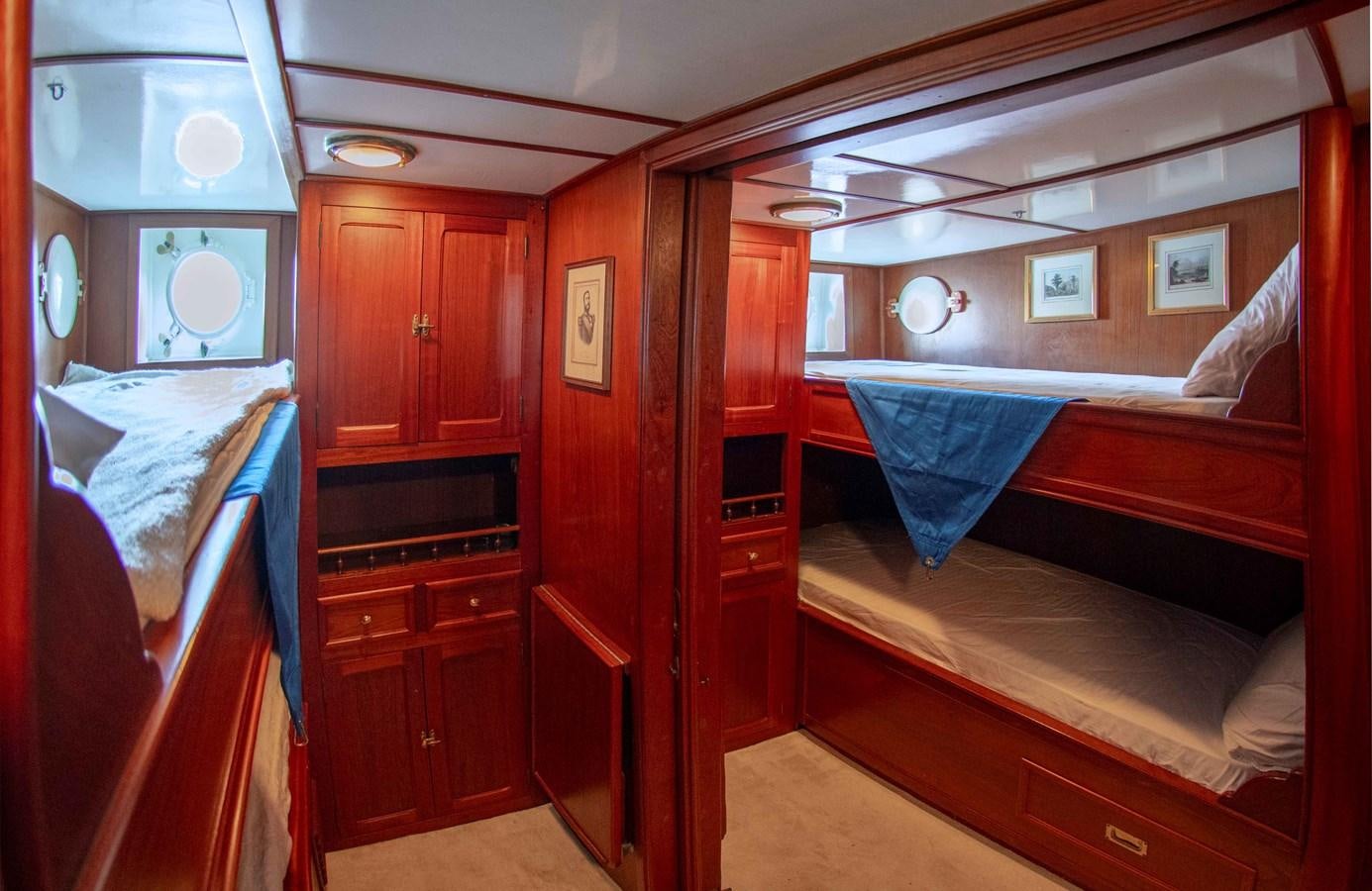 a room with a bed and a dresser aboard FOREVER Yacht for Sale