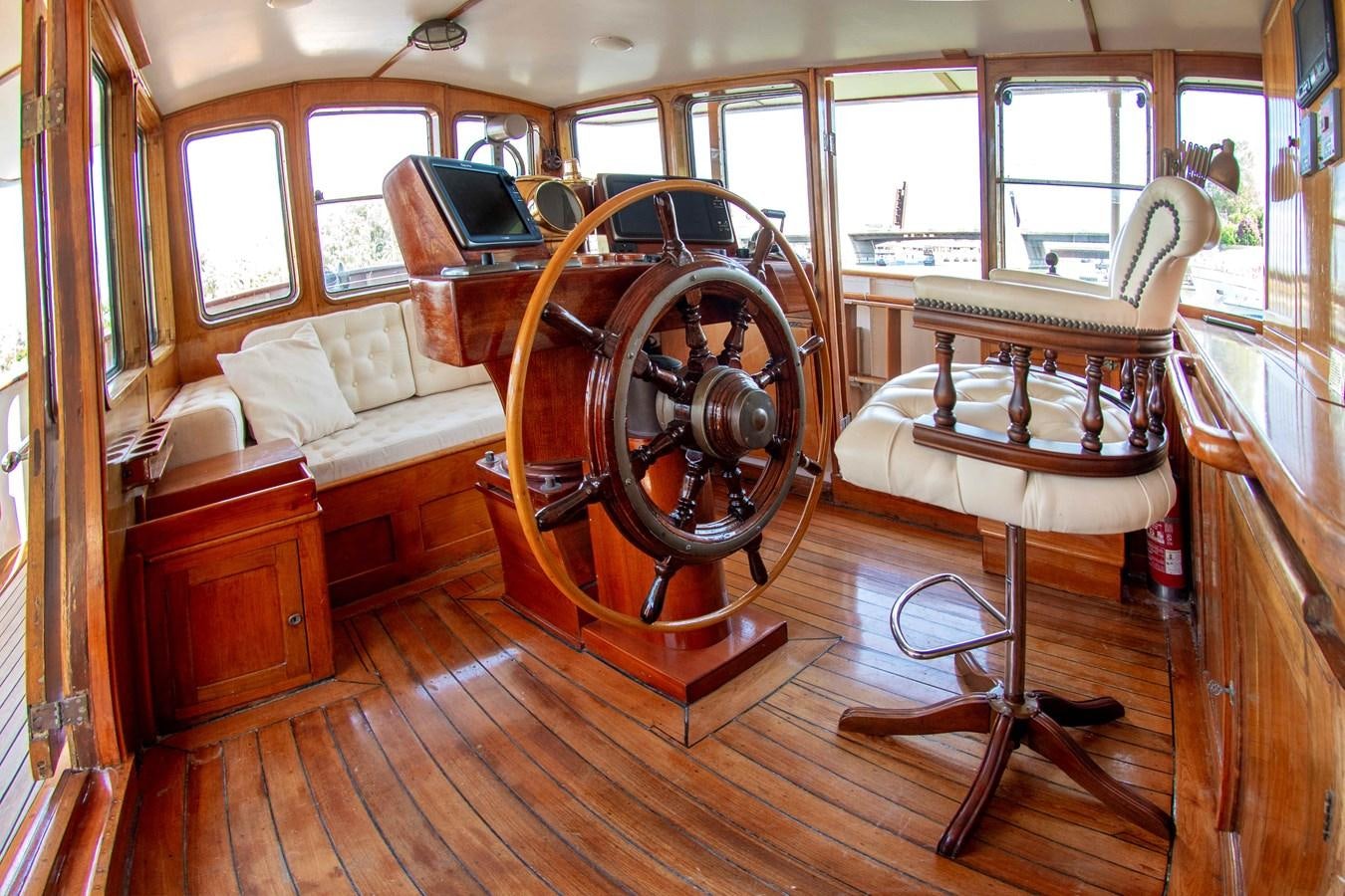 a room with a couch and a table and a chair aboard FOREVER Yacht for Sale