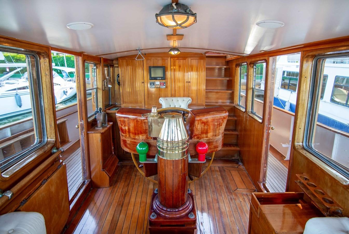 a room with wood cabinets and a table with a lamp on it aboard FOREVER Yacht for Sale