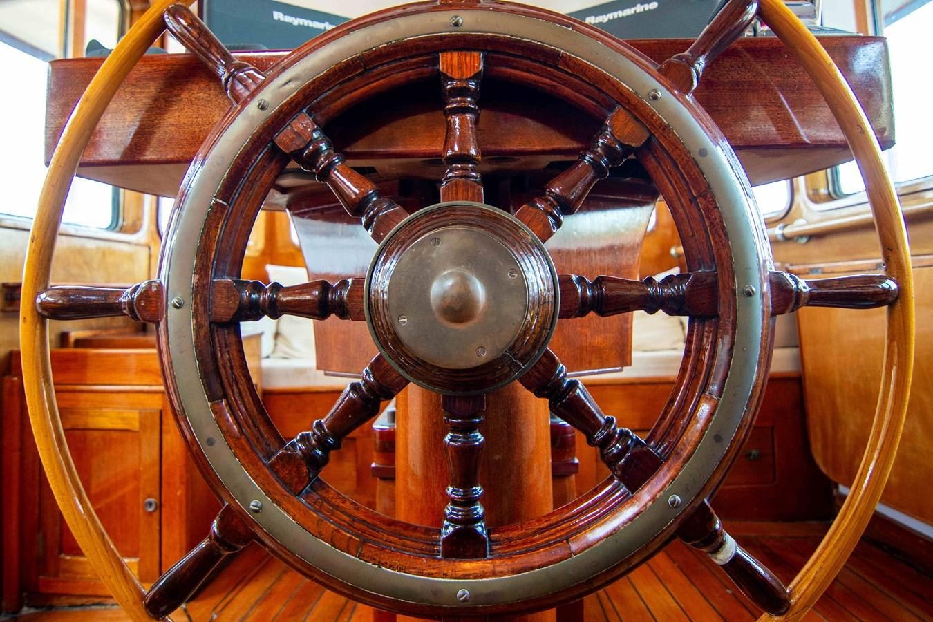 a close-up of a steering wheel aboard FOREVER Yacht for Sale