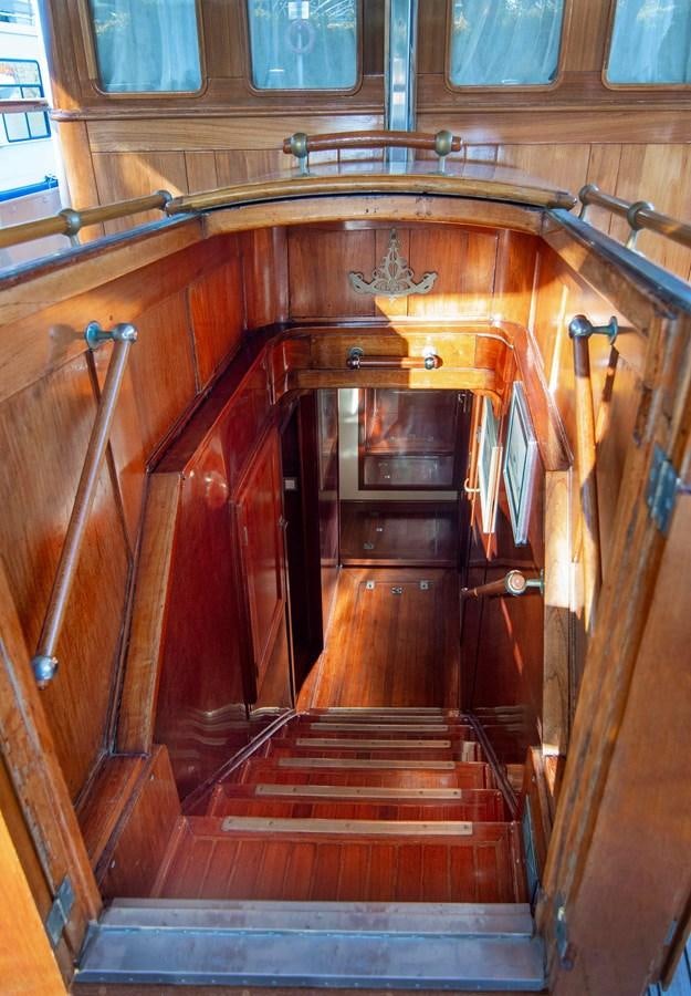 a wooden staircase with a glass door aboard FOREVER Yacht for Sale