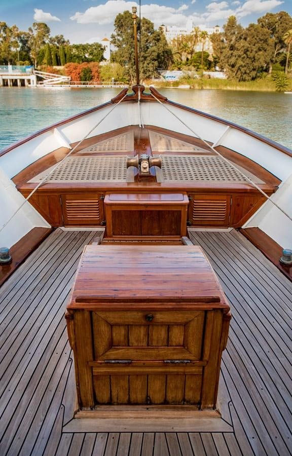 a wooden boat on a body of water aboard FOREVER Yacht for Sale