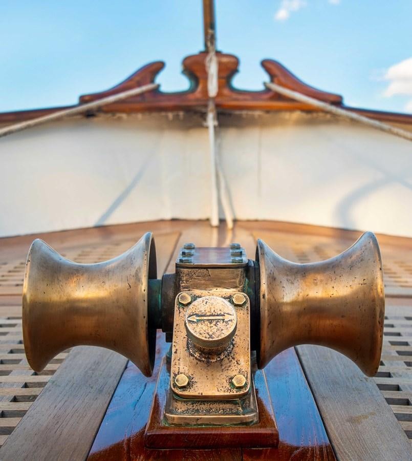 a golden metal object on a wooden surface aboard FOREVER Yacht for Sale