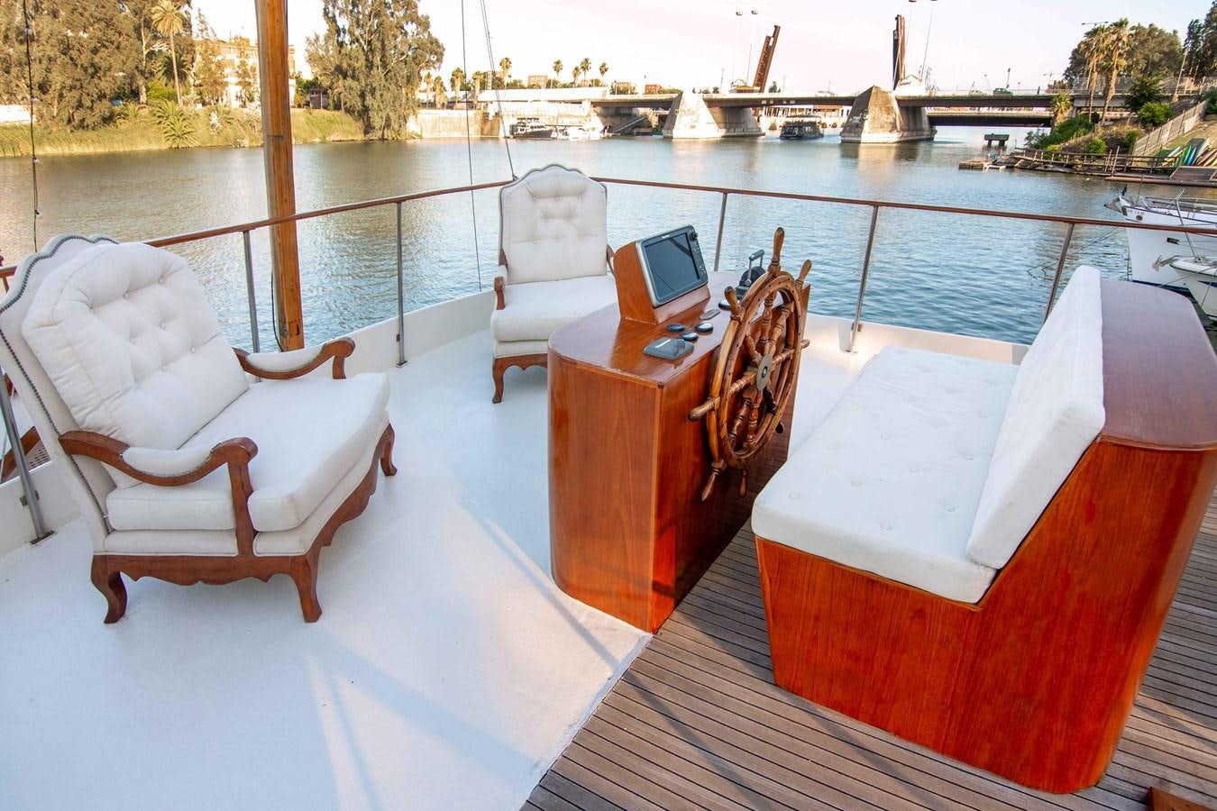 a deck with chairs and a laptop on it aboard FOREVER Yacht for Sale