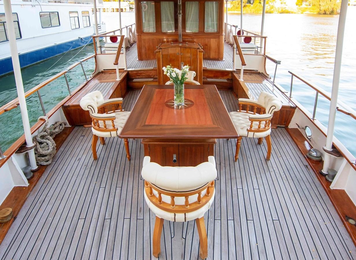 a table and chairs on a deck aboard FOREVER Yacht for Sale