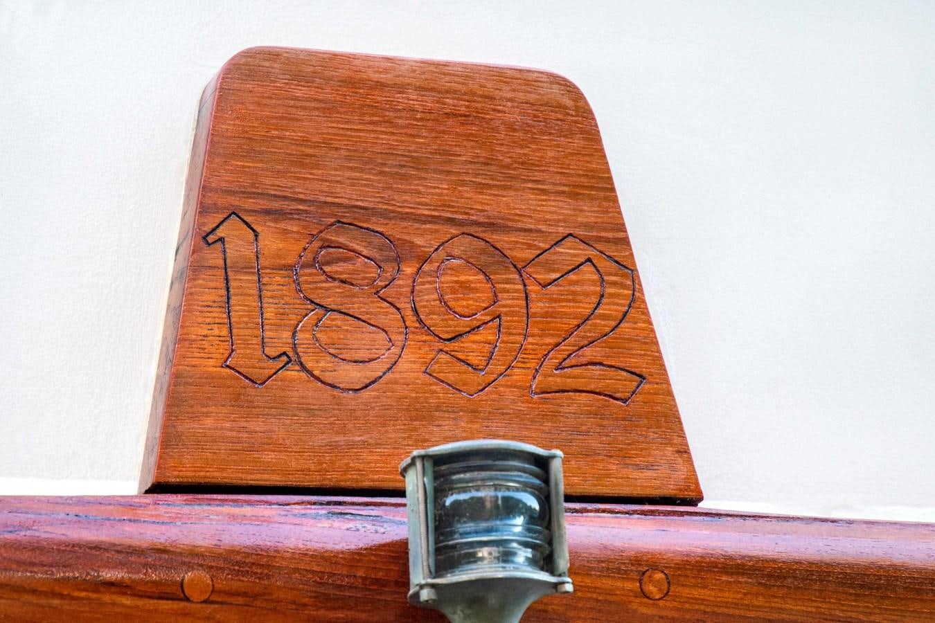 a wooden sign with a glass of water in it aboard FOREVER Yacht for Sale