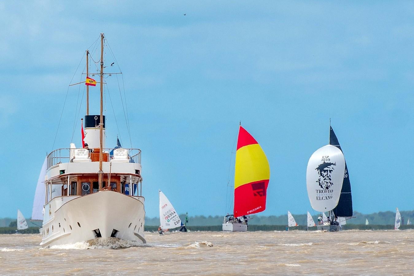 a boat and a flag on the beach aboard FOREVER Yacht for Sale