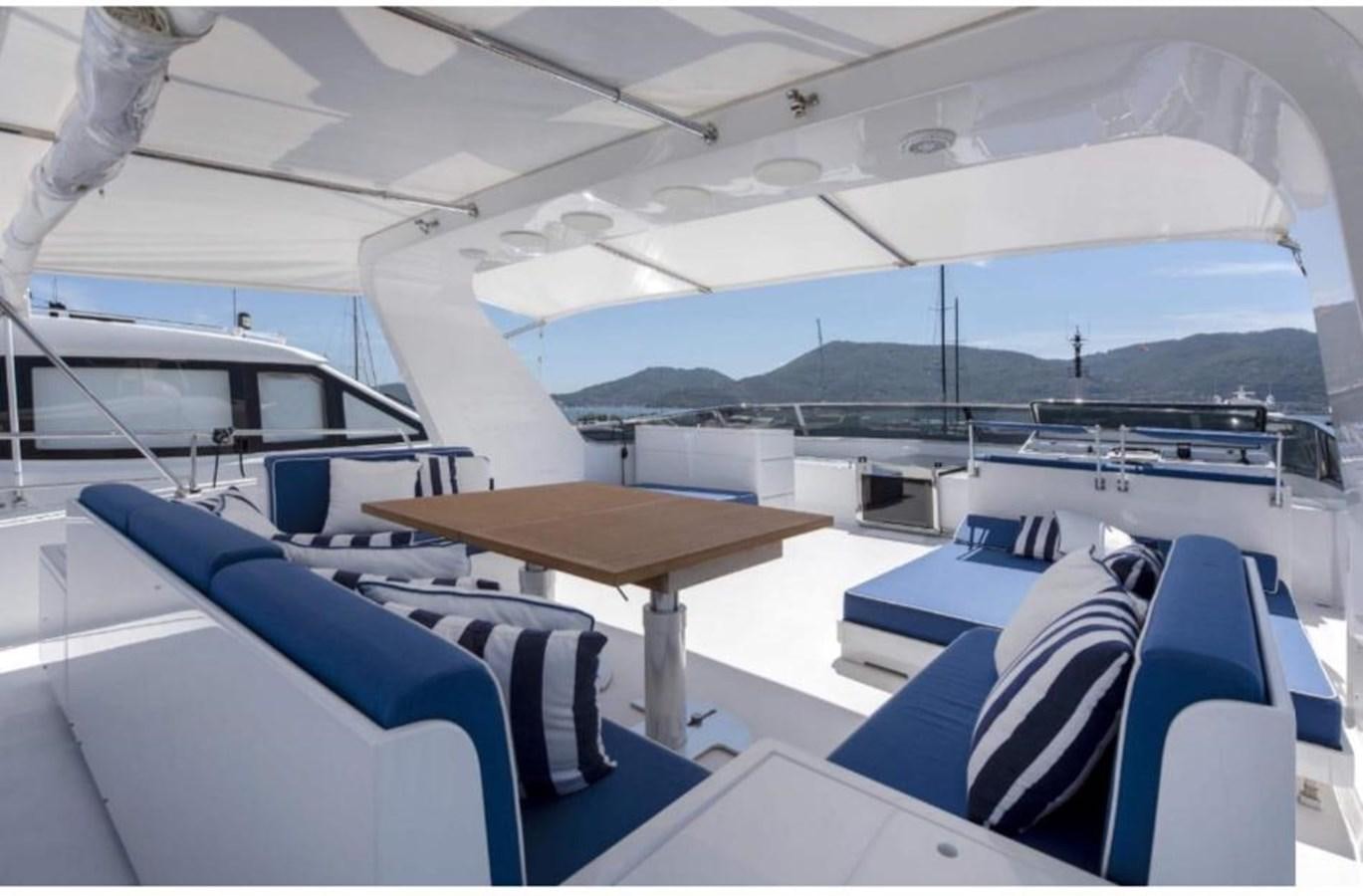 a boat with a table and chairs aboard FALCO Yacht for Sale