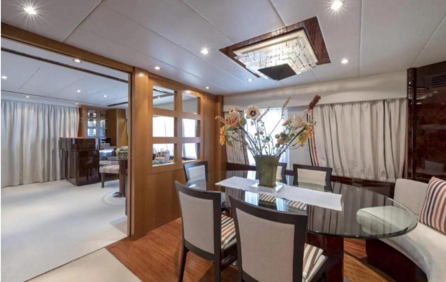 a room with a table and chairs aboard FALCO Yacht for Sale