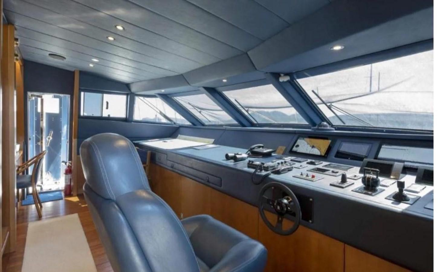 a room with a large table and chairs aboard FALCO Yacht for Sale