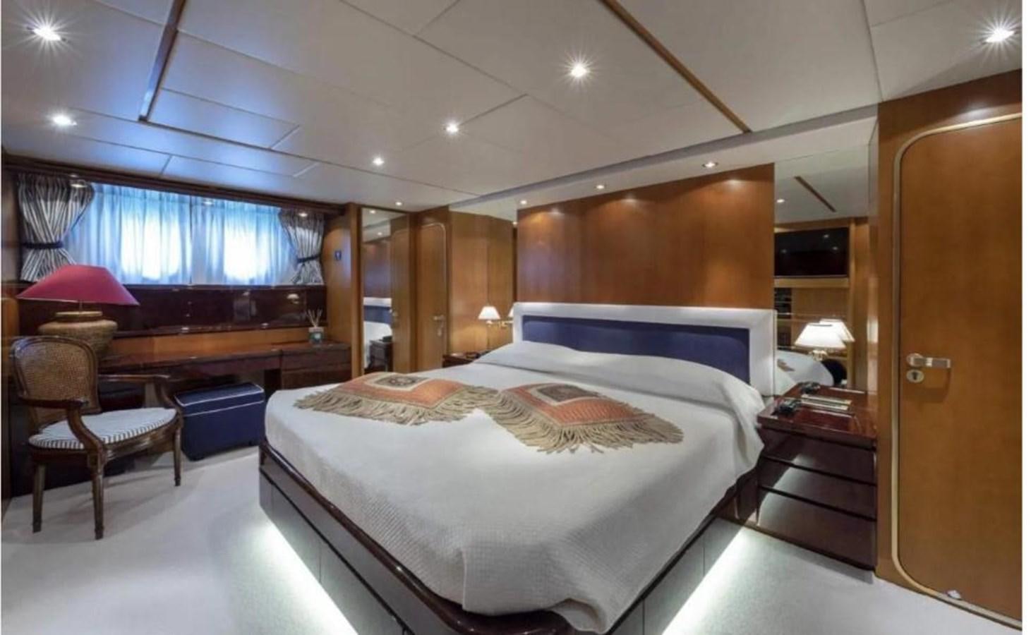 a bedroom with a bed and desk aboard FALCO Yacht for Sale