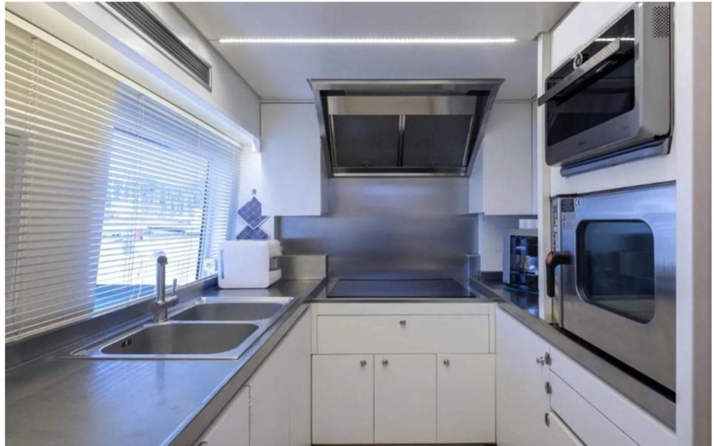 a kitchen with white cabinets aboard FALCO Yacht for Sale