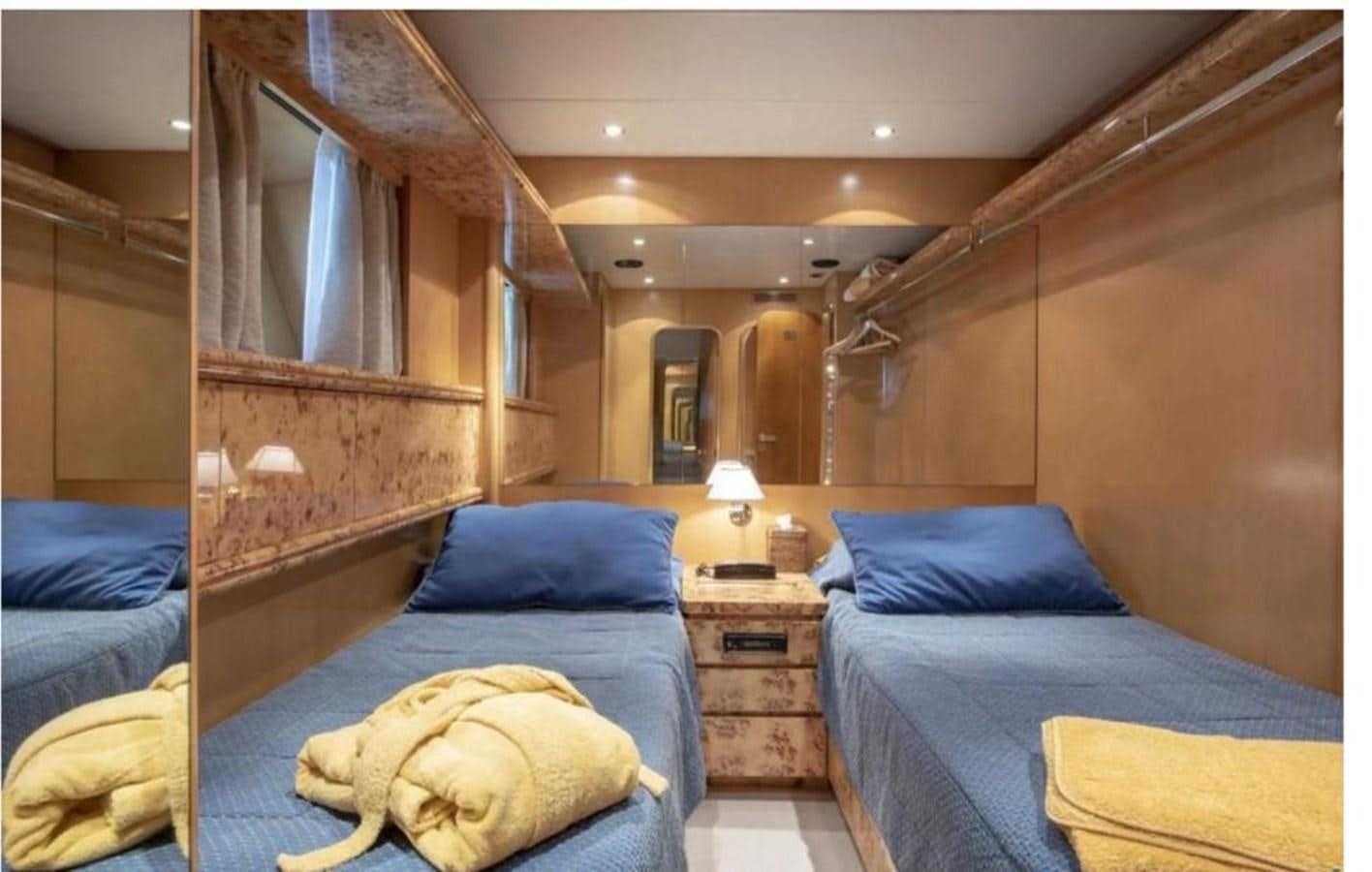 a room with a bed and a dresser aboard FALCO Yacht for Sale