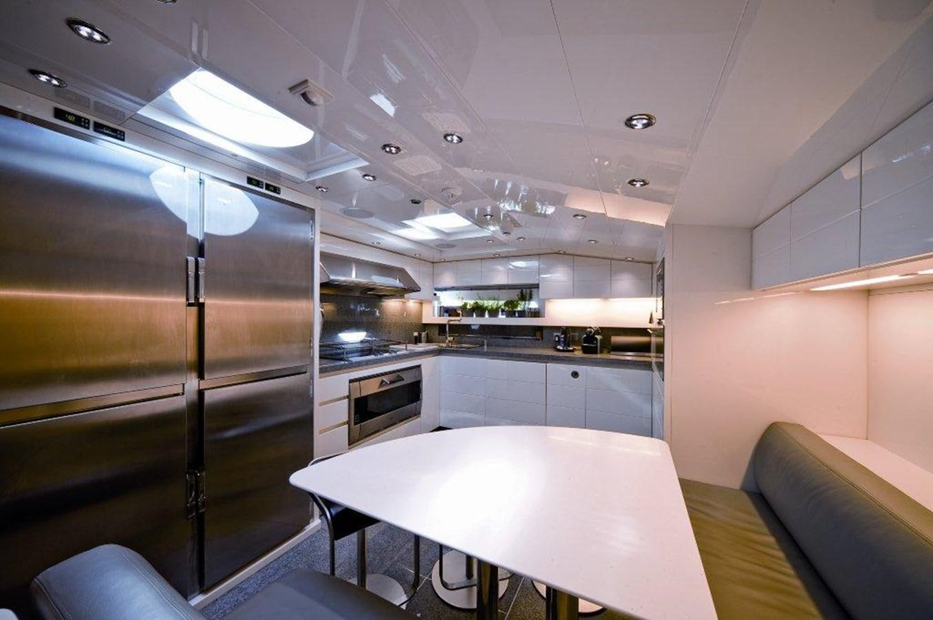 a modern kitchen with a glass wall aboard BALANDRAU Yacht for Sale