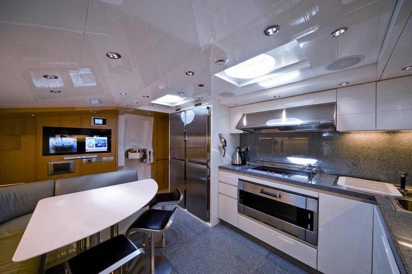 a kitchen with a table and chairs aboard BALANDRAU Yacht for Sale