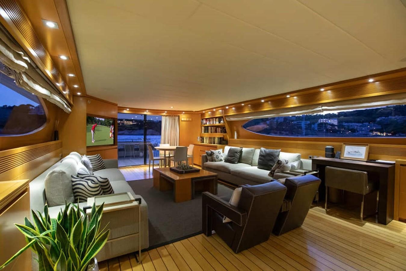 a living room with a large screen aboard BALANDRAU Yacht for Sale
