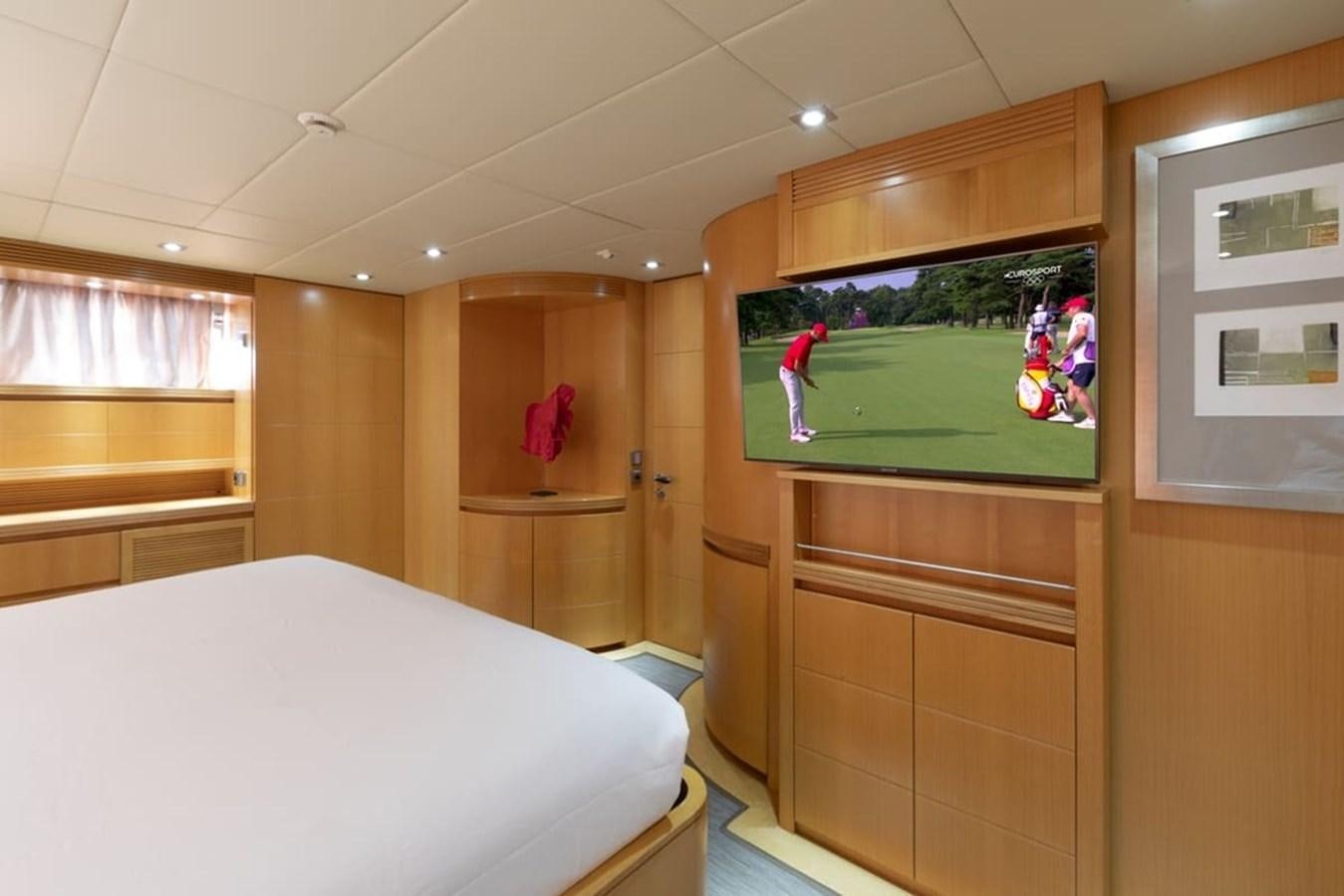a bedroom with a television aboard BALANDRAU Yacht for Sale