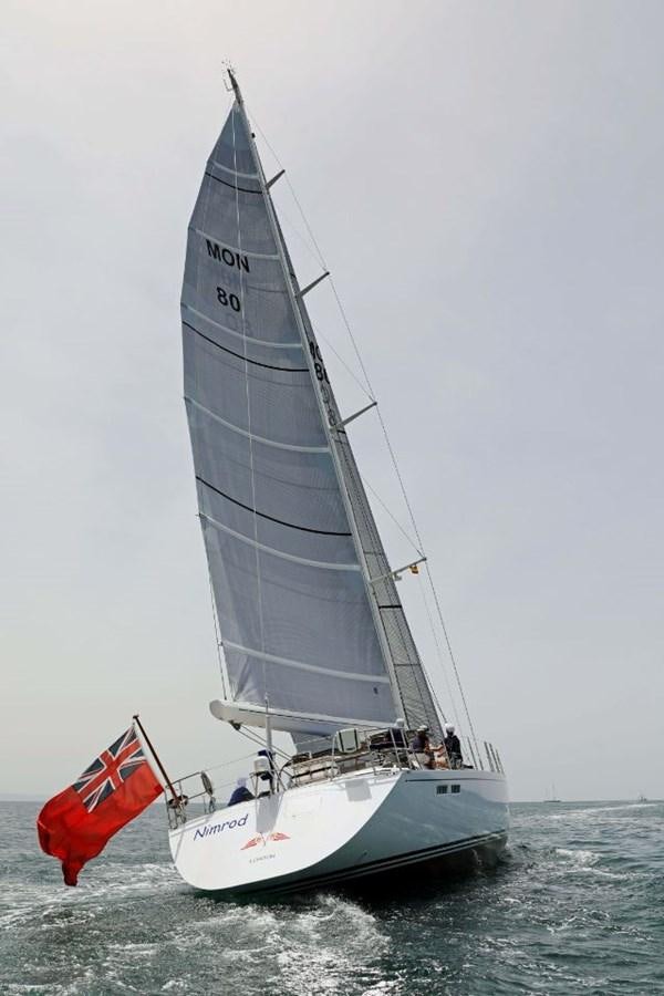 a sailboat with a red sail aboard NIMROD Yacht for Sale