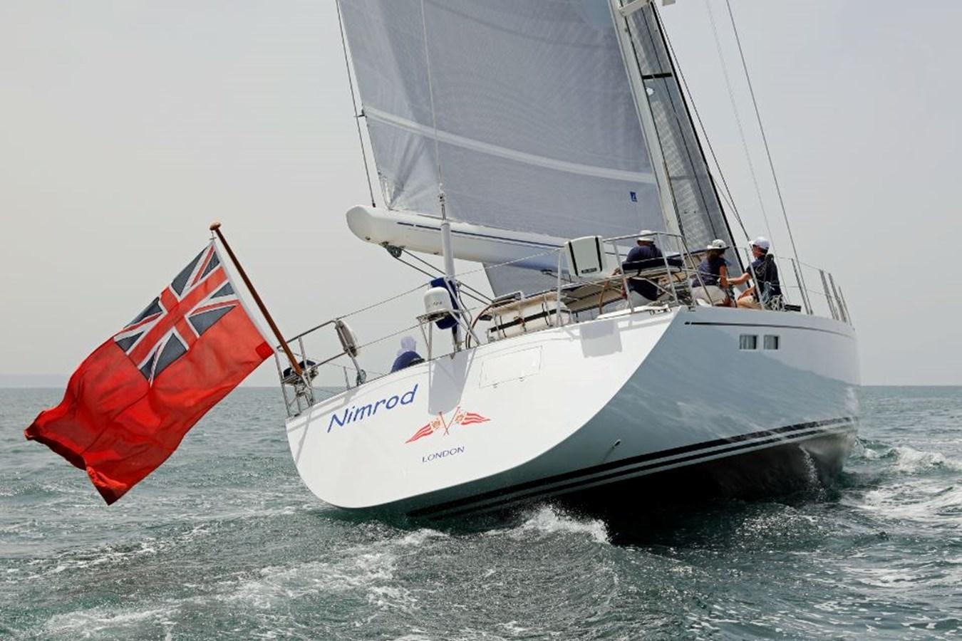 a sailboat with a red sail aboard NIMROD Yacht for Sale