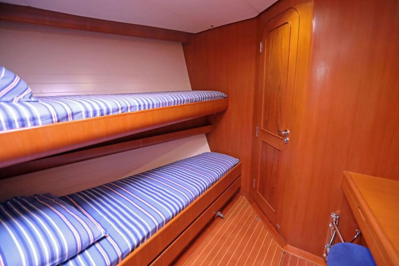 a room with a bed and a closet aboard NIMROD Yacht for Sale