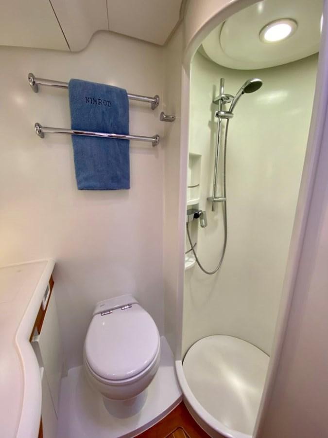 a bathroom with a toilet and a shower aboard NIMROD Yacht for Sale