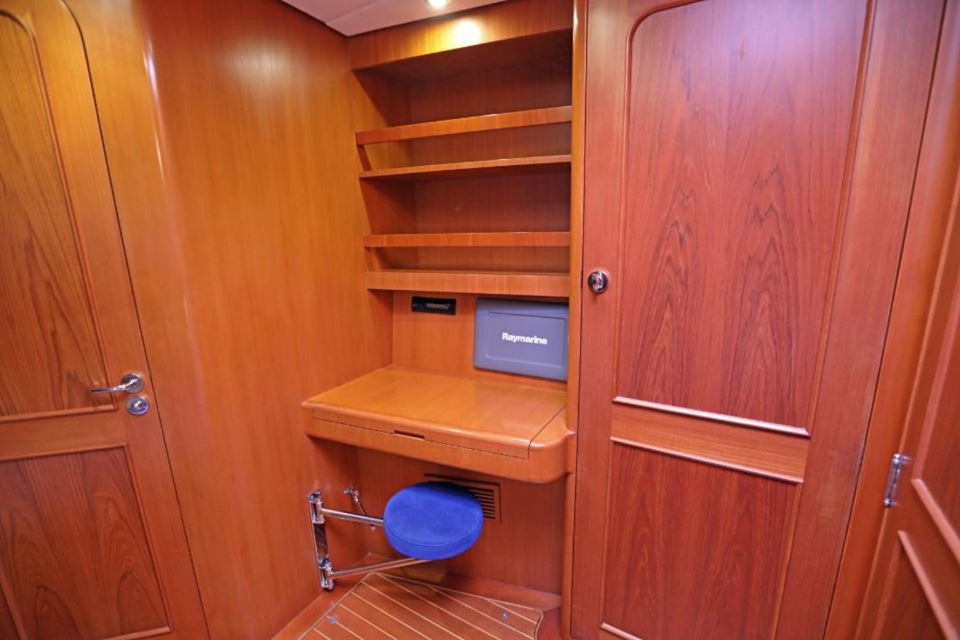 a wooden cabinet with a computer on it aboard NIMROD Yacht for Sale
