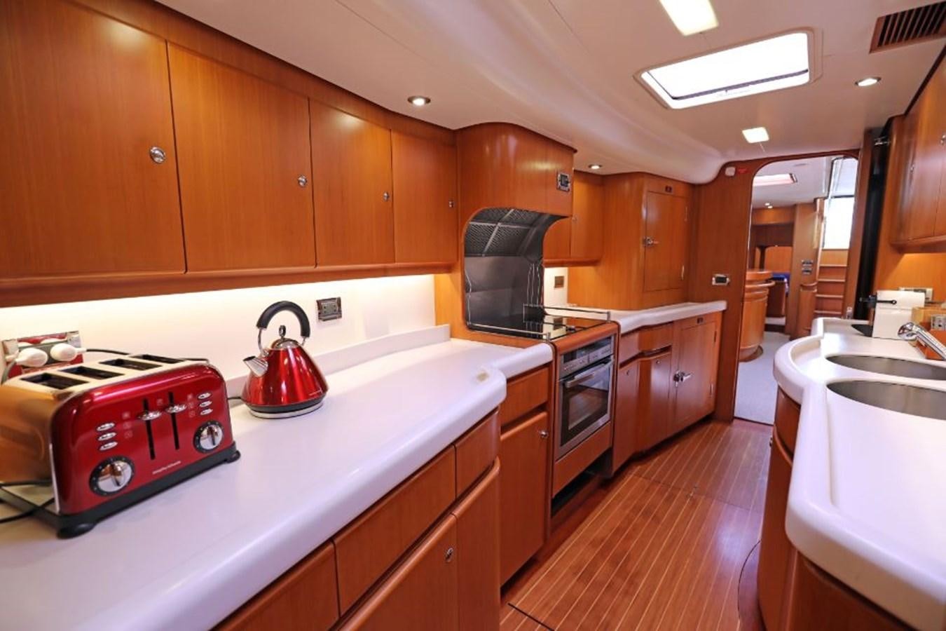 a kitchen with wooden cabinets aboard NIMROD Yacht for Sale