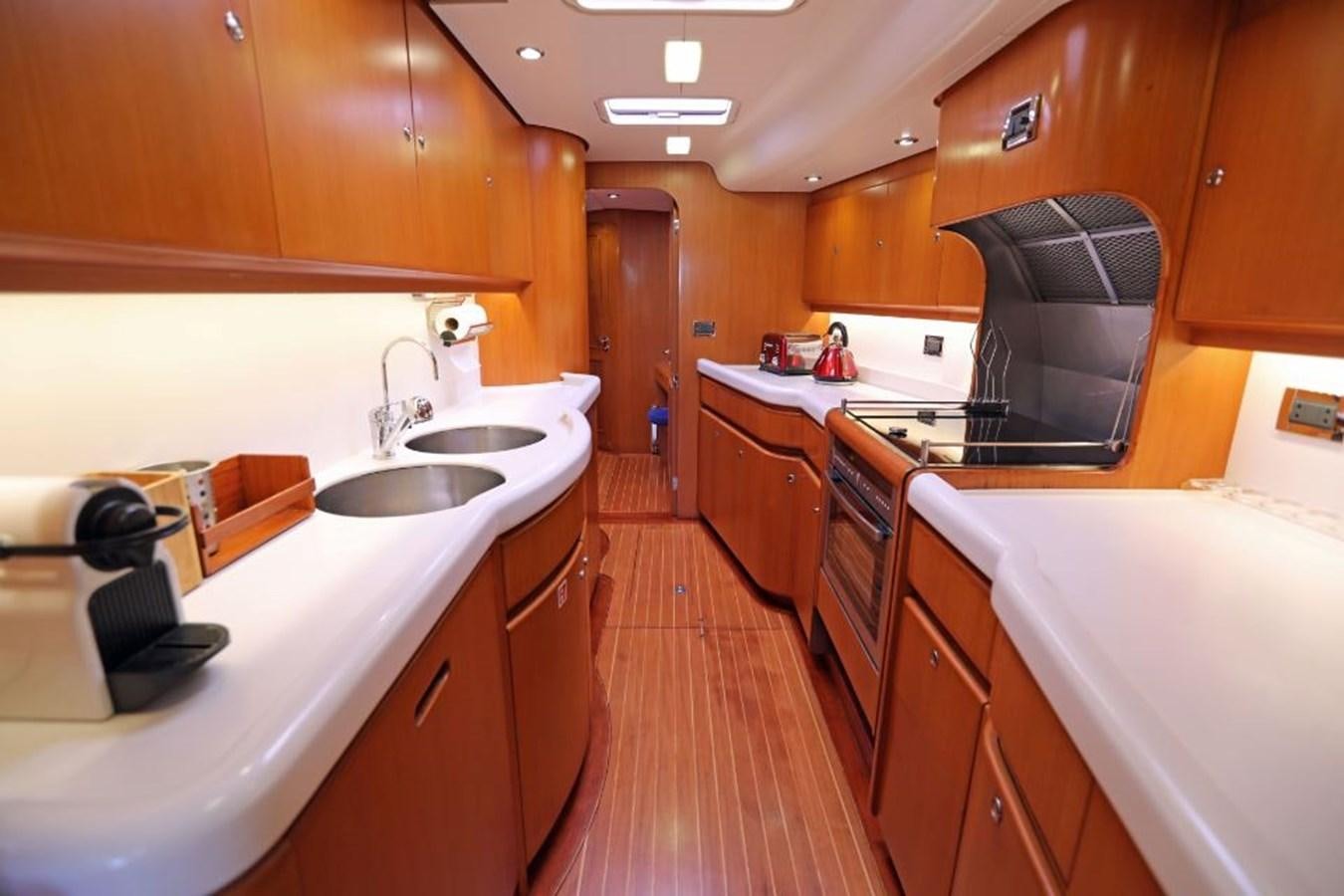 a kitchen with wooden cabinets aboard NIMROD Yacht for Sale